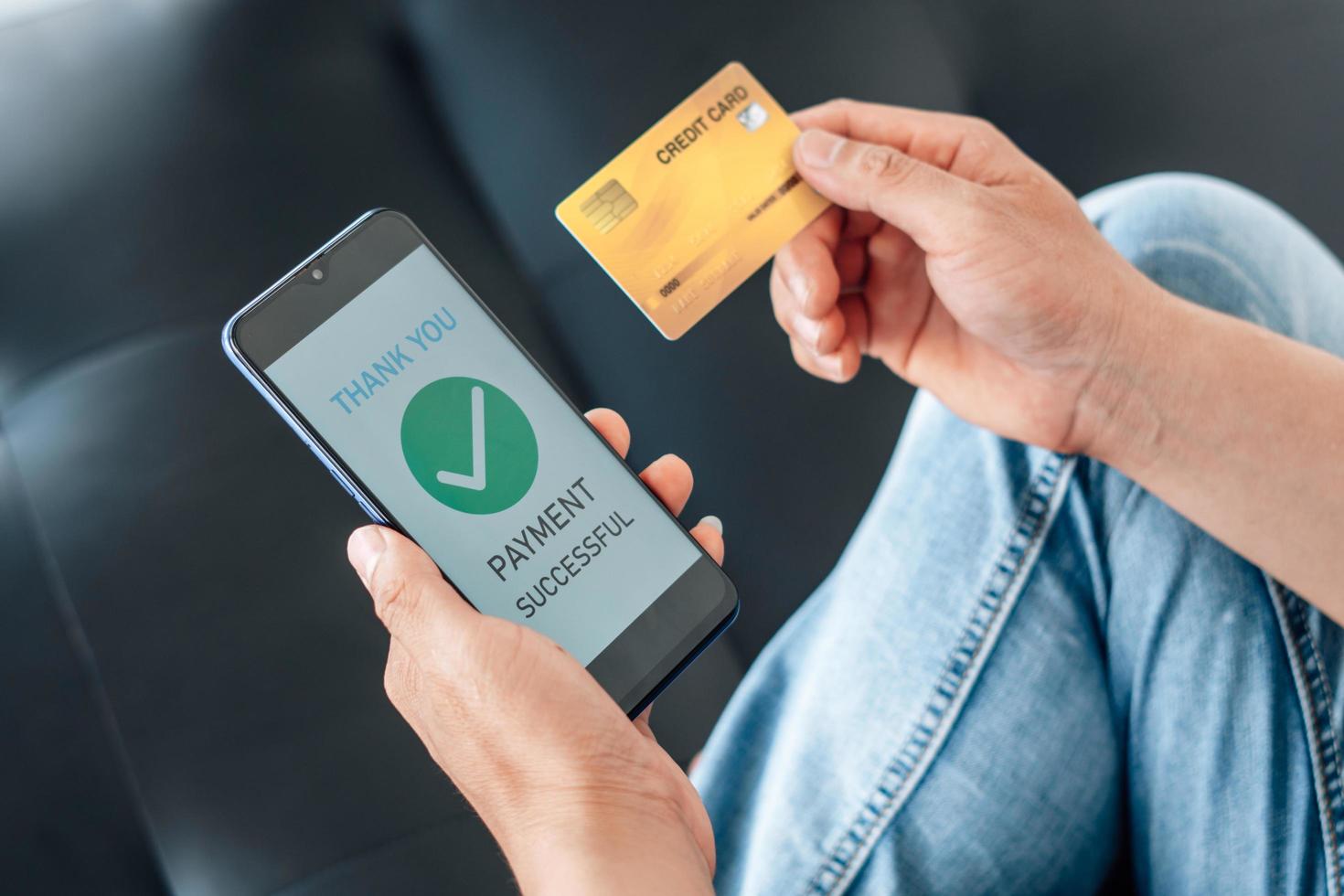 Online payment, internet banking and online shopping concept. Businessman hold credit card and using smartphone payment successful on table. photo