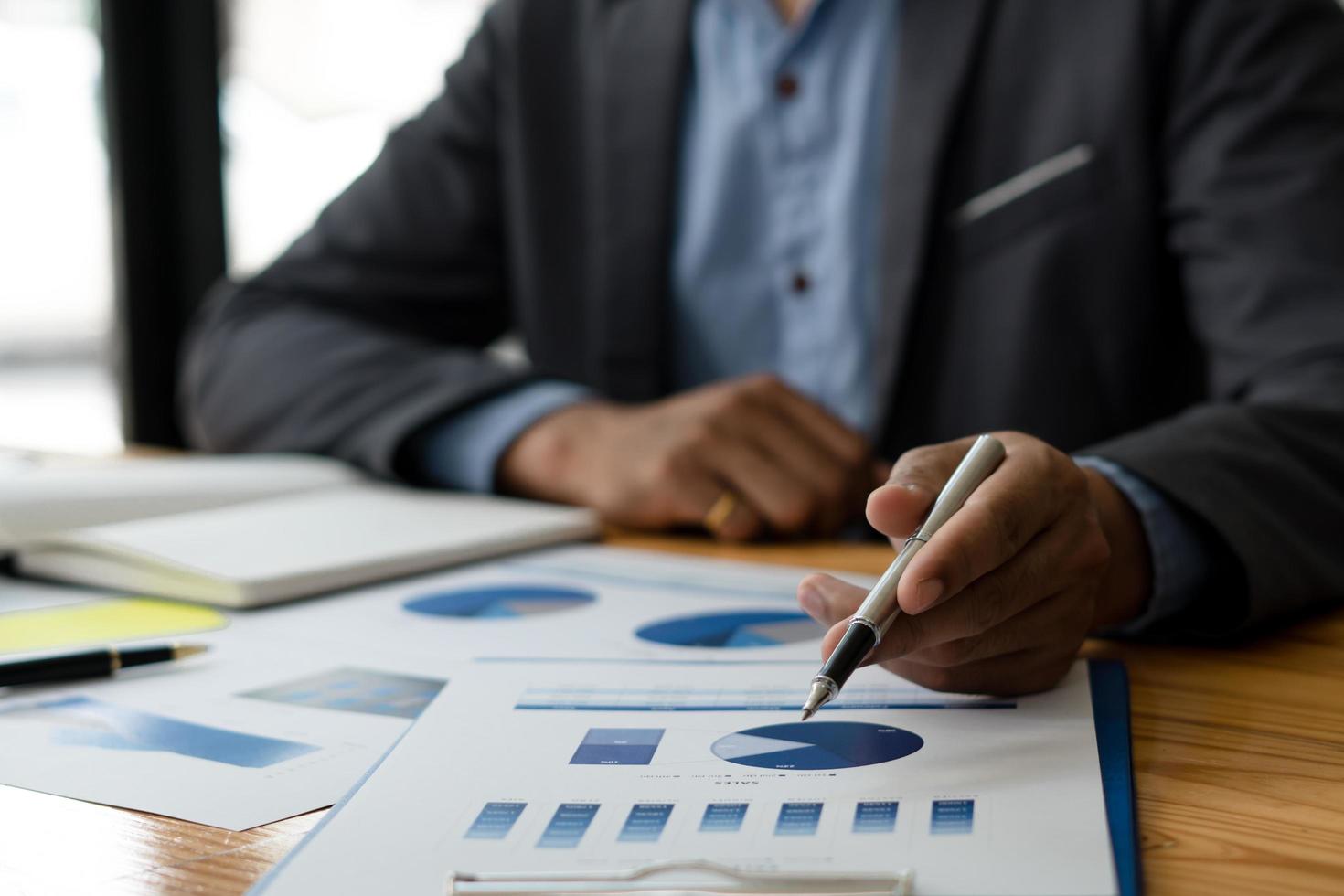strategy analysis concept, Businessman working financial Manager Researching Process accounting calculate analyse market graph data stock information review on the table in office. photo