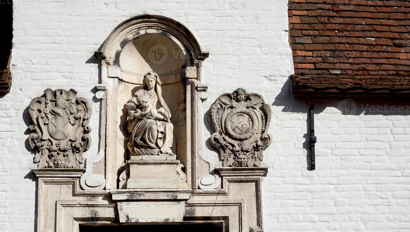 Historical door way decoration in Bruges, Belgium, Europe photo
