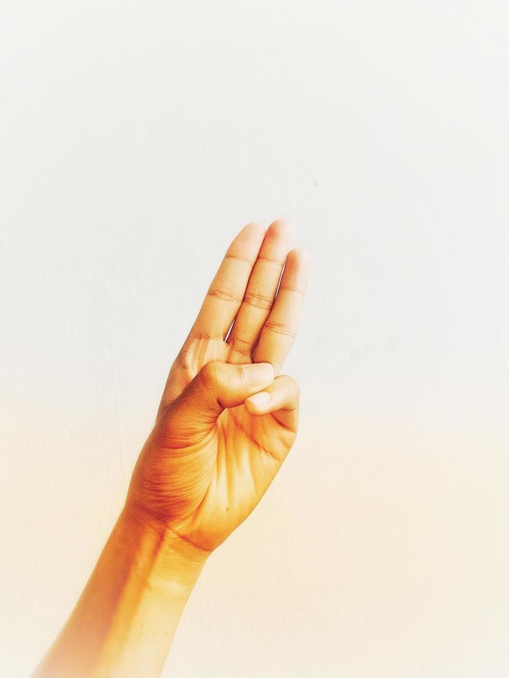 Close-up of hands showing gestures on textured background. photo