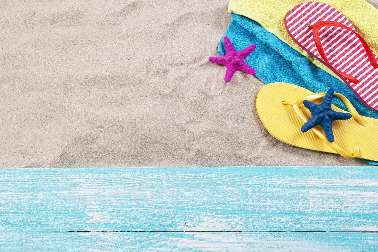 Sand copy space. Sand background top view.Beach towel, beach slippers and starfish photo