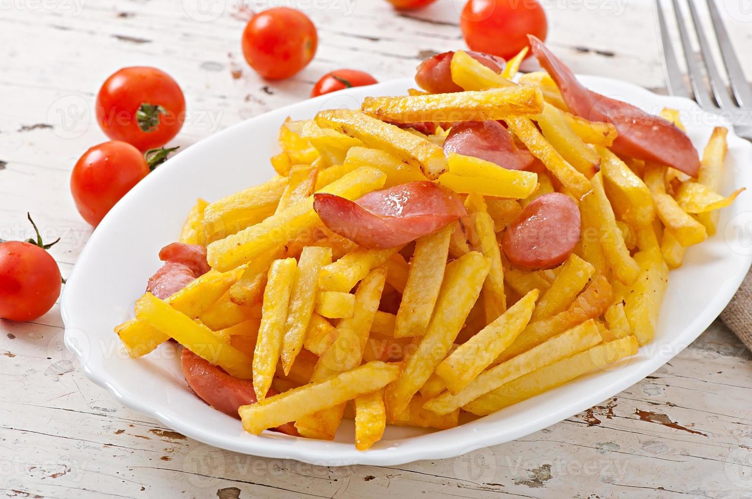 Fried potatoes with sausage on a plate photo