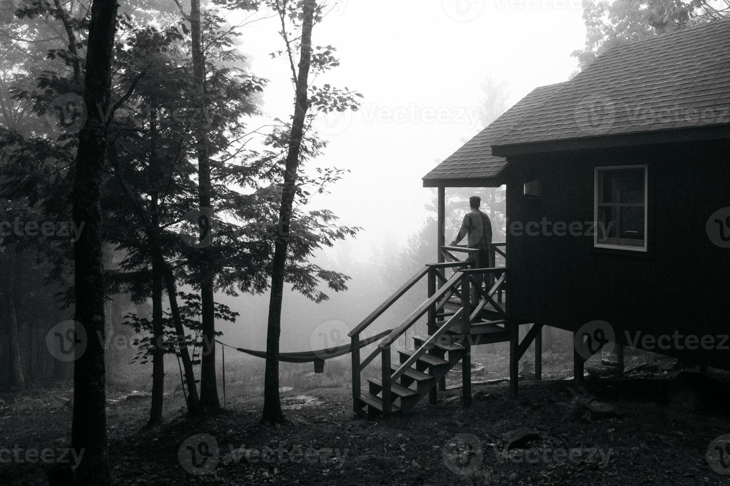 Black and white of a silhouette of a person at a house photo