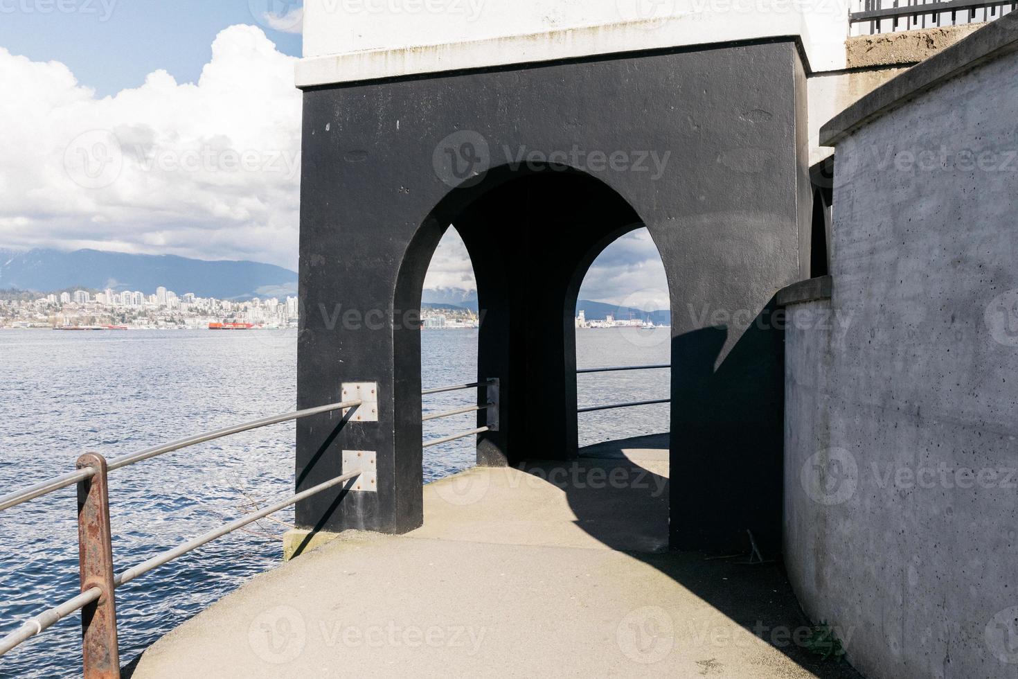 Walking path with an archway by the ocean photo