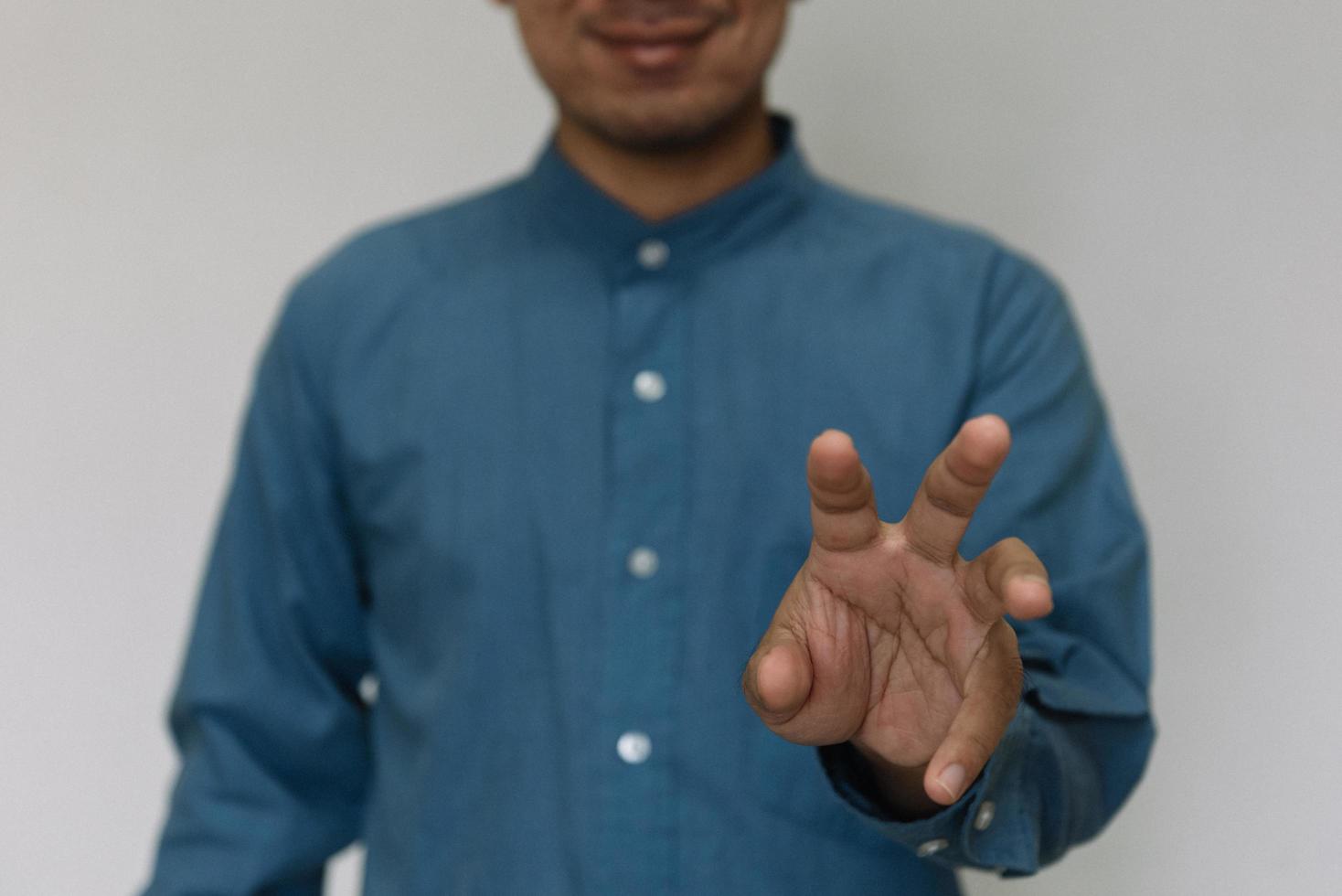 Young handsome man wearing light blue shirt  with different behaviors at work photo