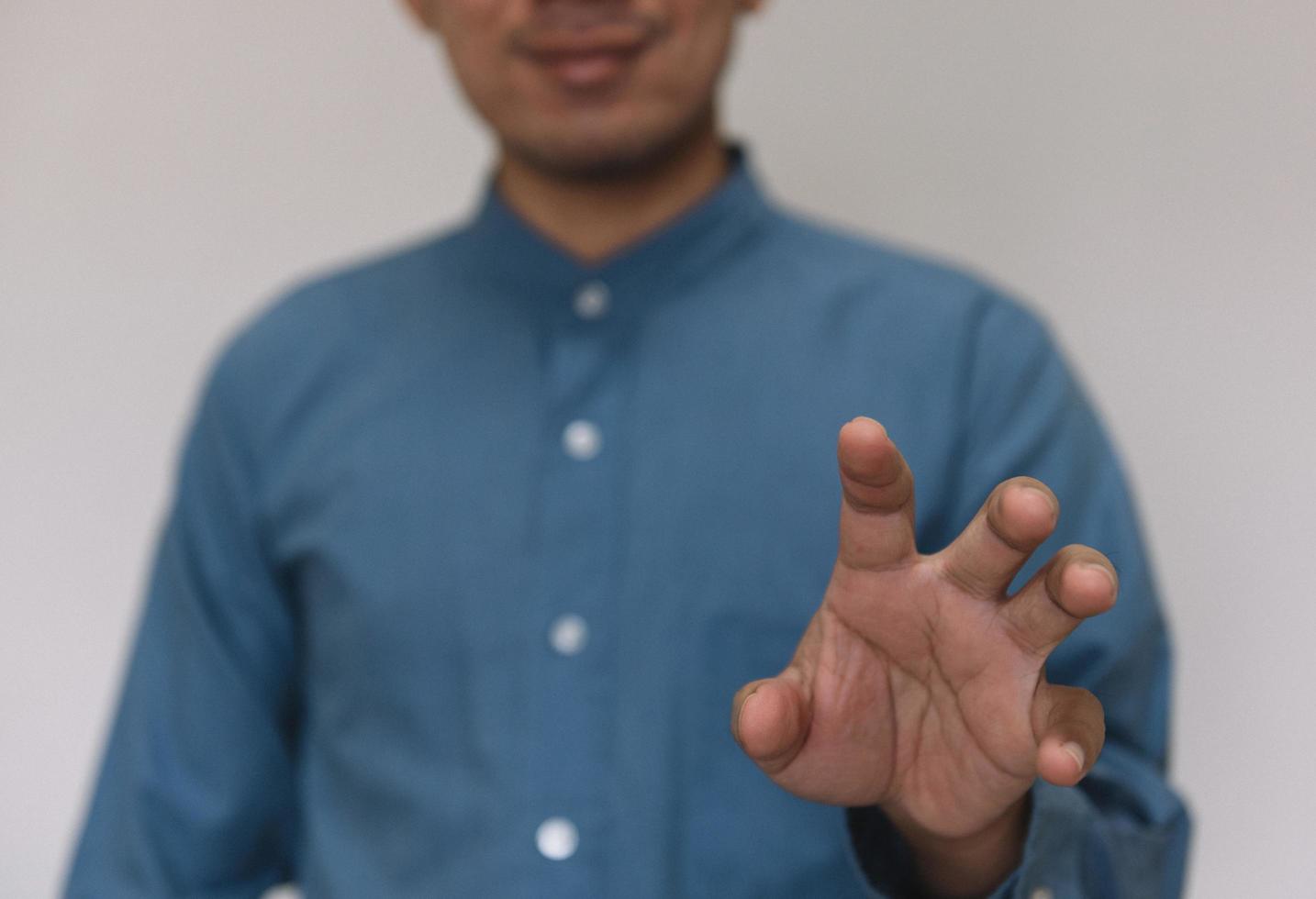 Young handsome man wearing light blue shirt  with different behaviors at work photo