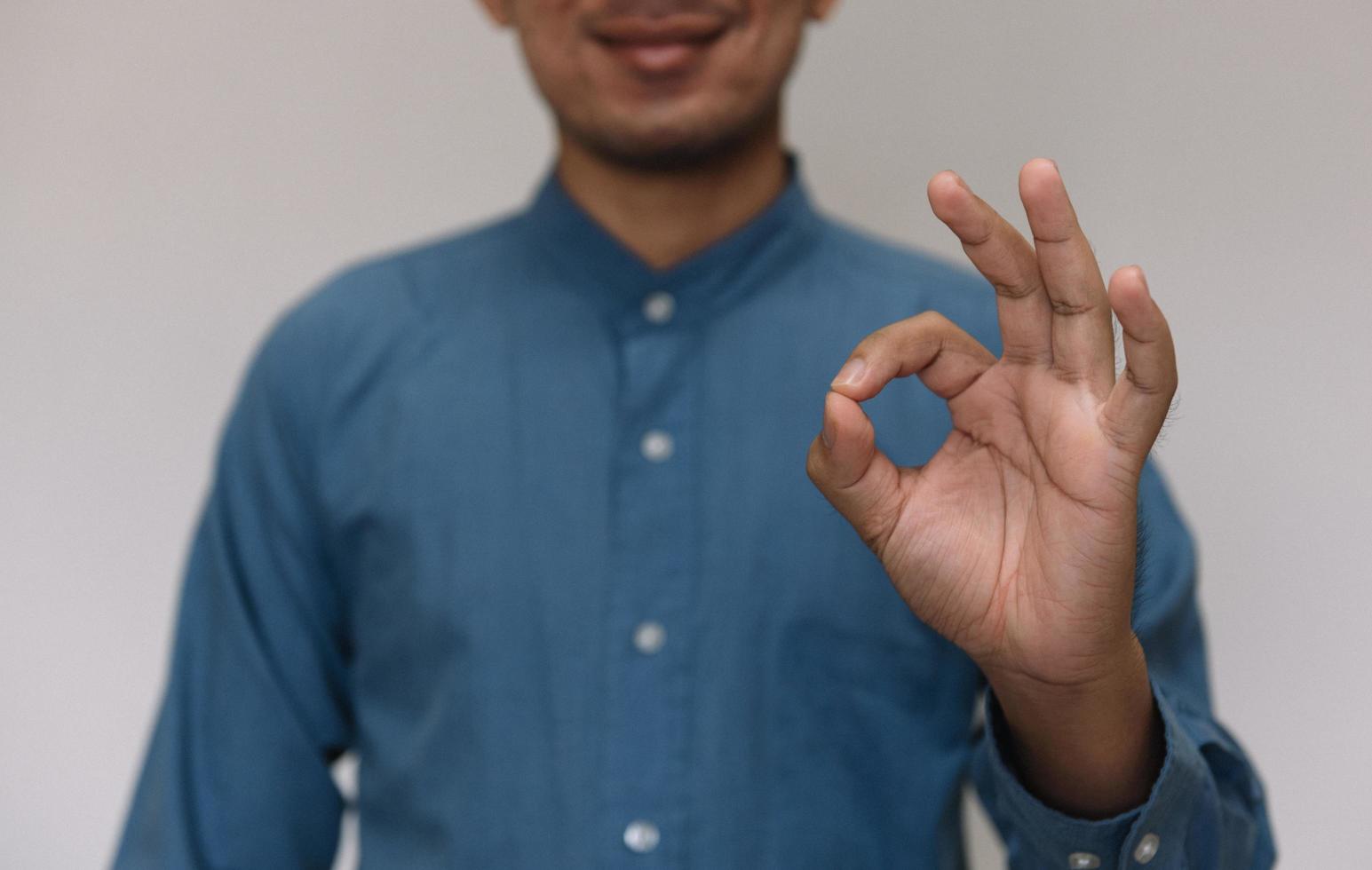 Young handsome man wearing light blue shirt  with different behaviors at work photo