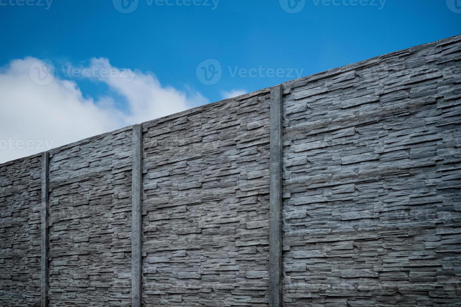 Fence of Pyrenean stone panels. Artificial concrete panels imitating natural stone. photo