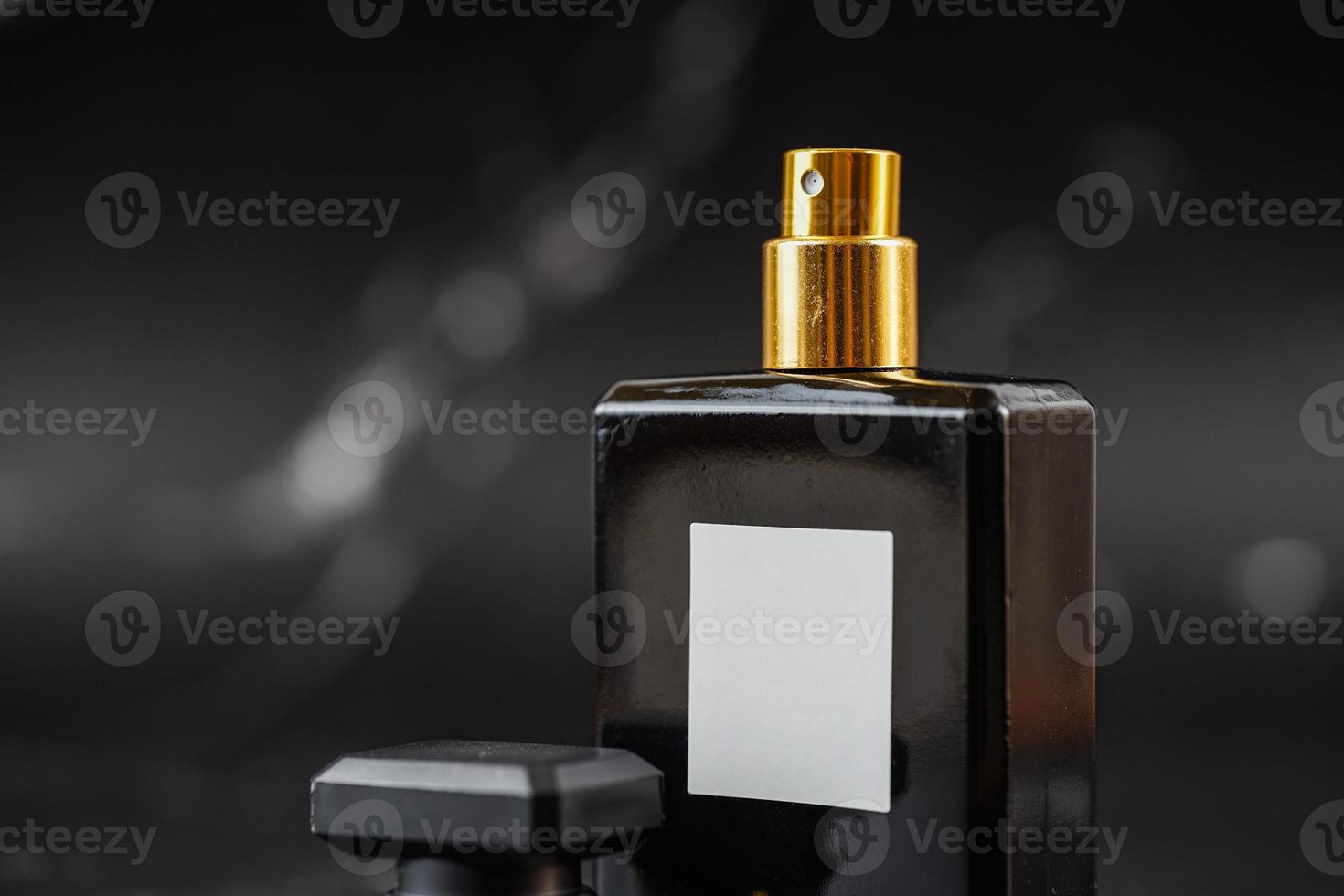 beautiful perfume bottle on black marble background photo