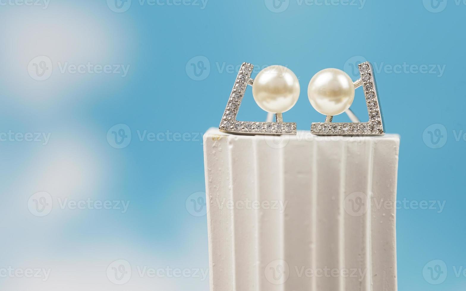 A beautiful Pearl Ear studs. Close-up of white pearl earrings. photo