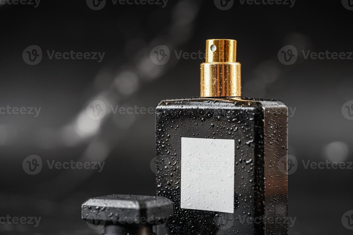 beautiful perfume bottle on black marble background photo