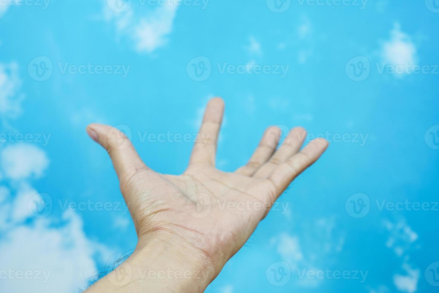 hand symbol isolated from sky background. concept of sign language photo