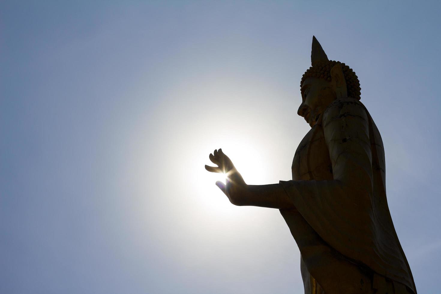 Silhouette standing Buddha. photo