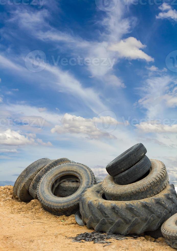 Old vehicle tires soil sky. photo