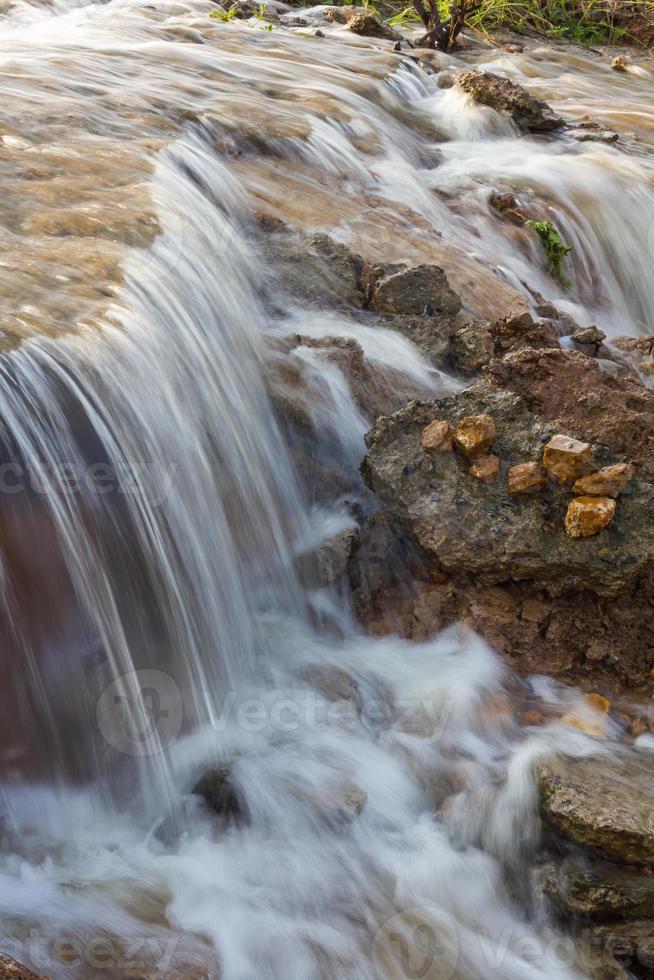 Blurred stream waterfall. photo