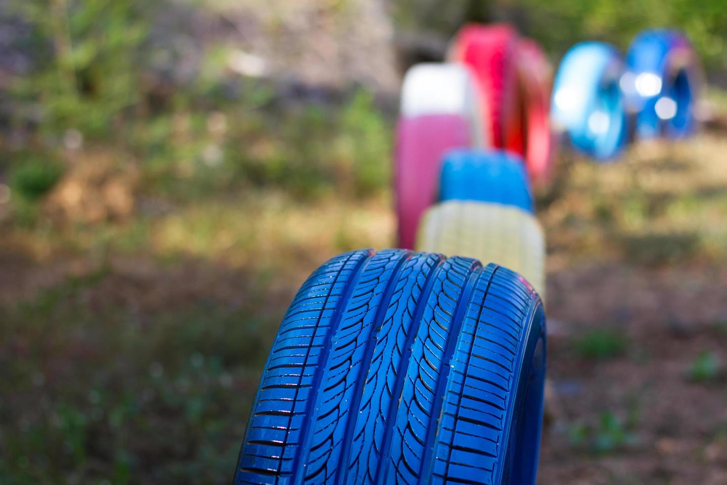 Colorful rubber wheels on the ground. photo