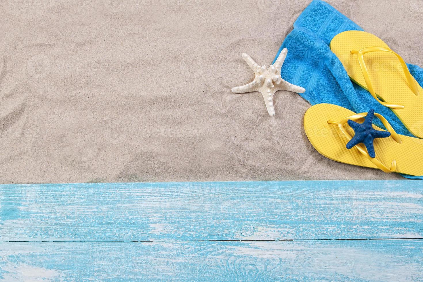 Sand copy space. Sand background top view.Beach towel, beach slippers and starfish photo