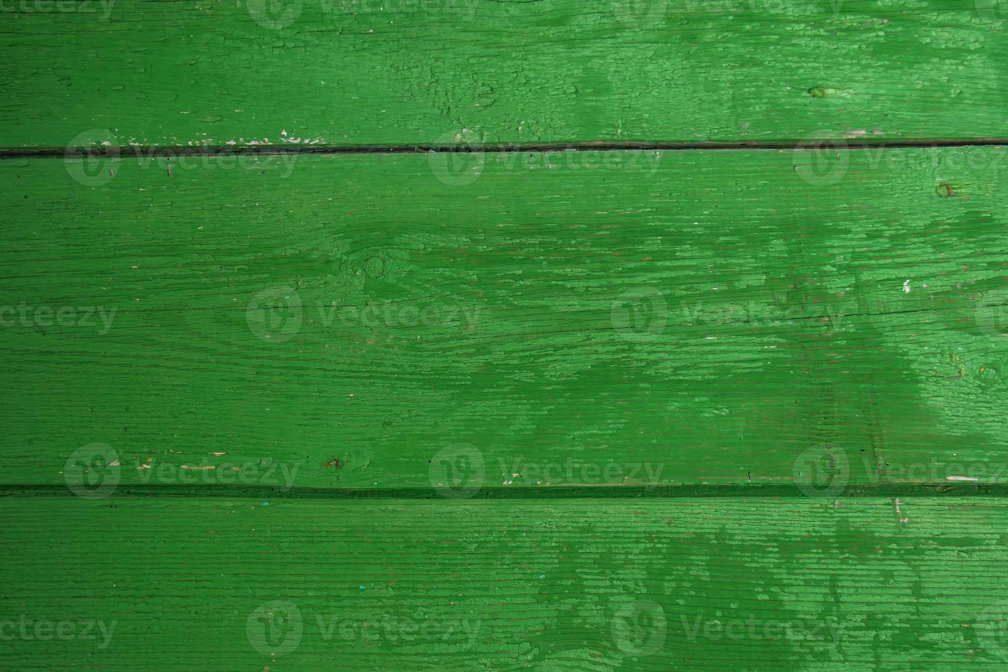 Background from old green boards. Close-up of cracks and chips in paint. photo