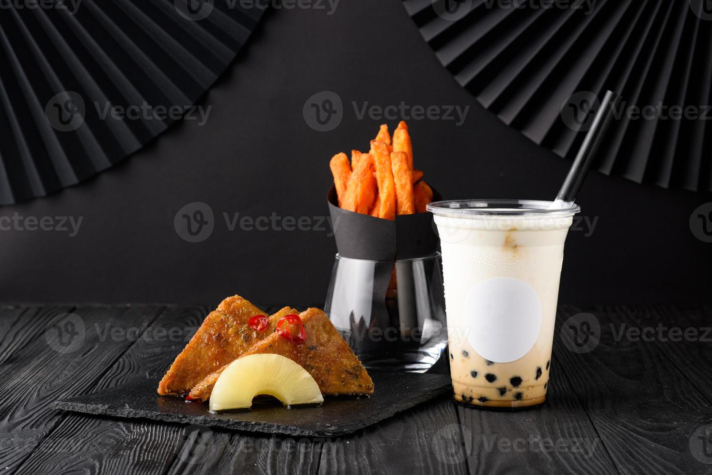 Milk bubble tea with tapioca and fried chicken with sweet potatoes. photo