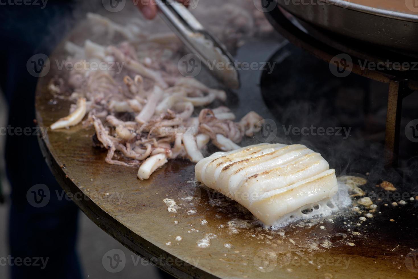 Cooking shrimp, prawn skewers on grill at street food festival - close up photo