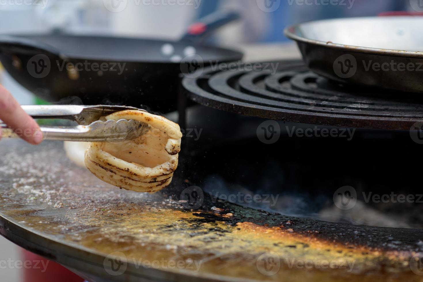 Cooking shrimp, prawn skewers on grill at street food festival - close up photo