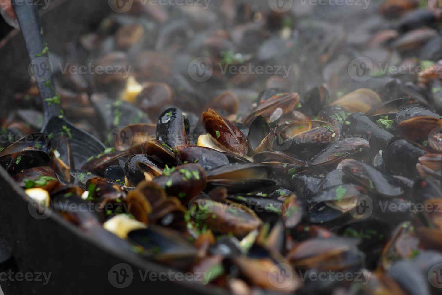 Close up of cooked mussels at a street food festival, ready to eat seafood photographed with soft focus photo