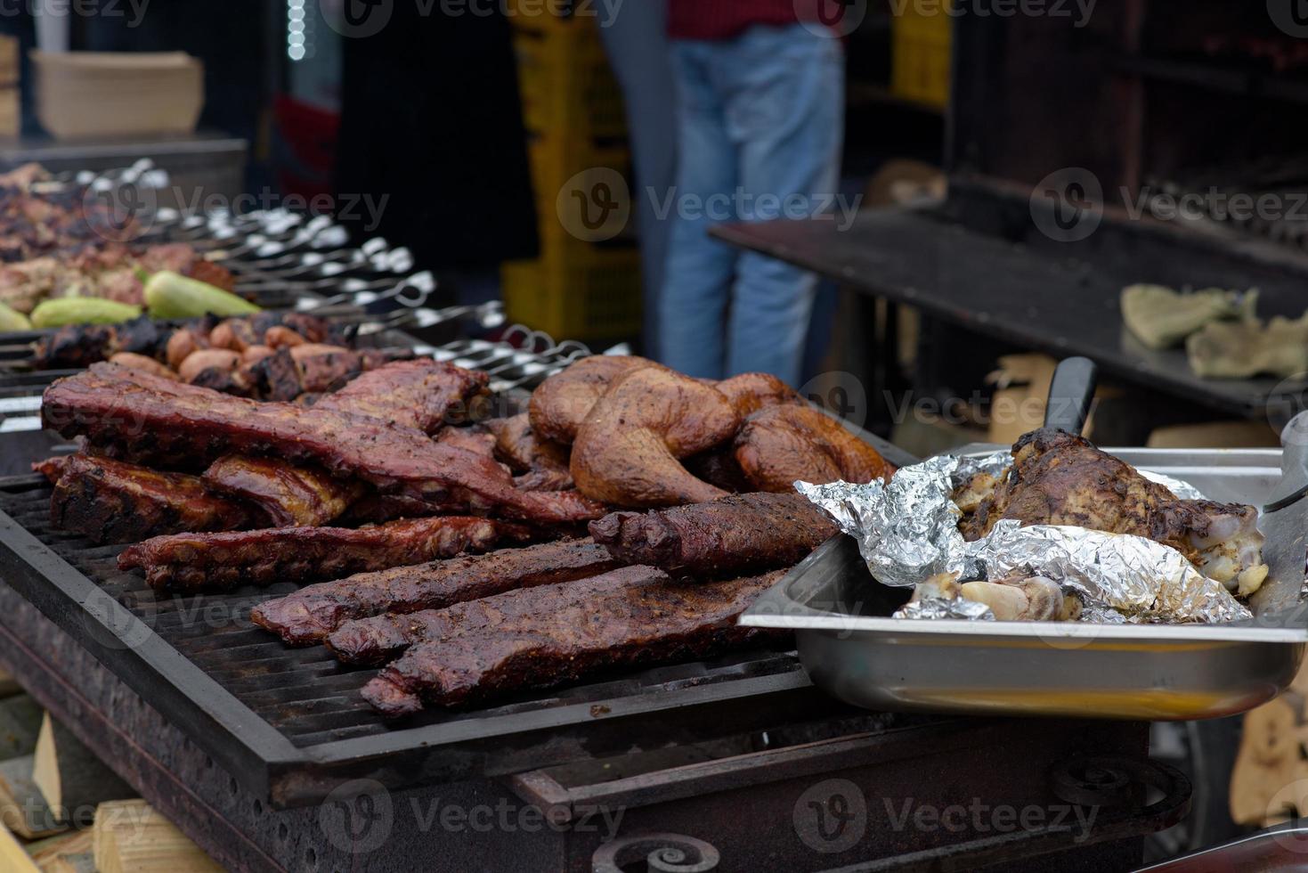 Grilled skewers of meat on the coals, with smoke. street food. photo