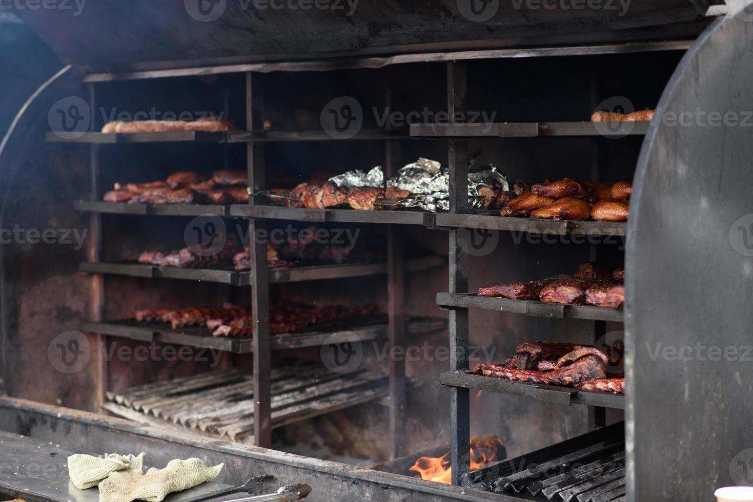 Grilled skewers of meat on the coals, with smoke. street food. photo
