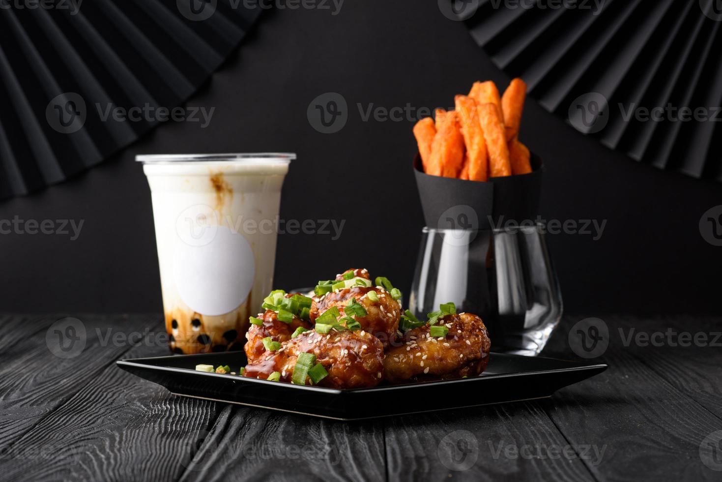 Milk bubble tea with tapioca and fried chicken with sweet potatoes. photo