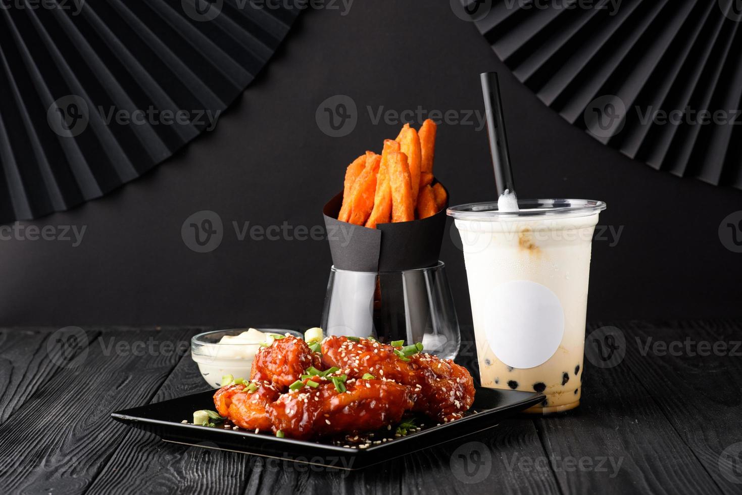 Milk bubble tea with tapioca and fried chicken with sweet potatoes. photo