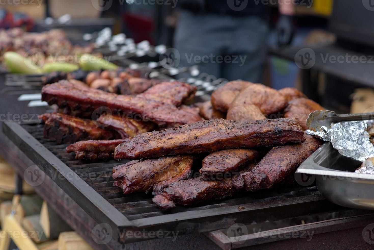 Grilled skewers of meat on the coals, with smoke. street food. photo