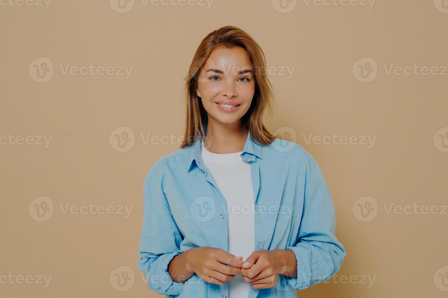 Portrait of caucasian woman with long stright light brown hair in casual clothes photo