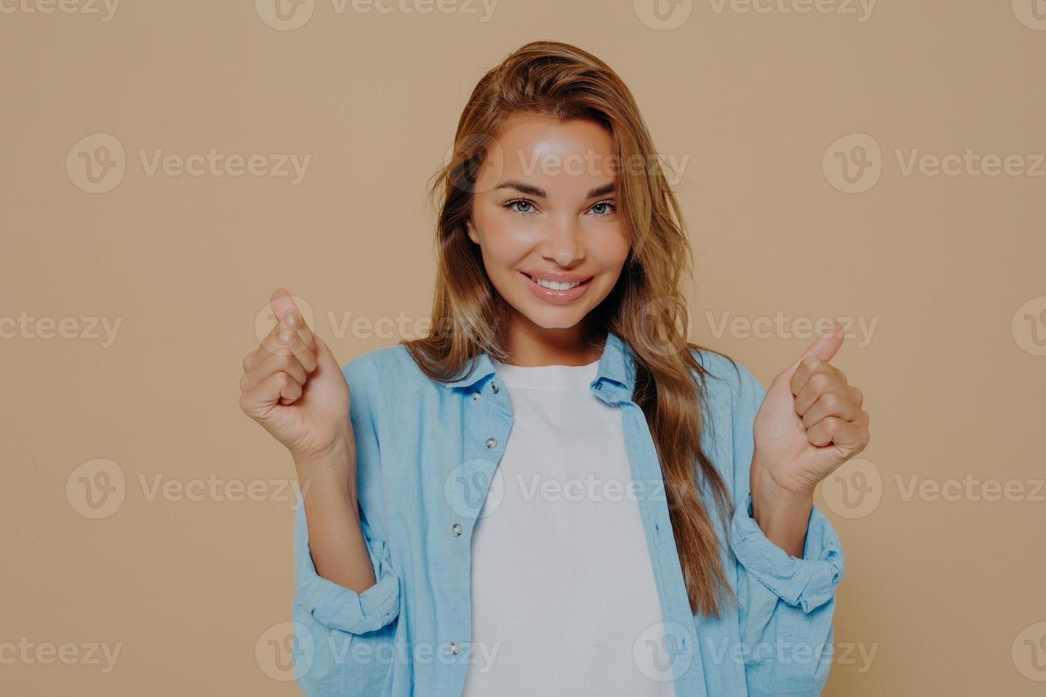 Overjoyed young european lady clenches fists with triumph photo
