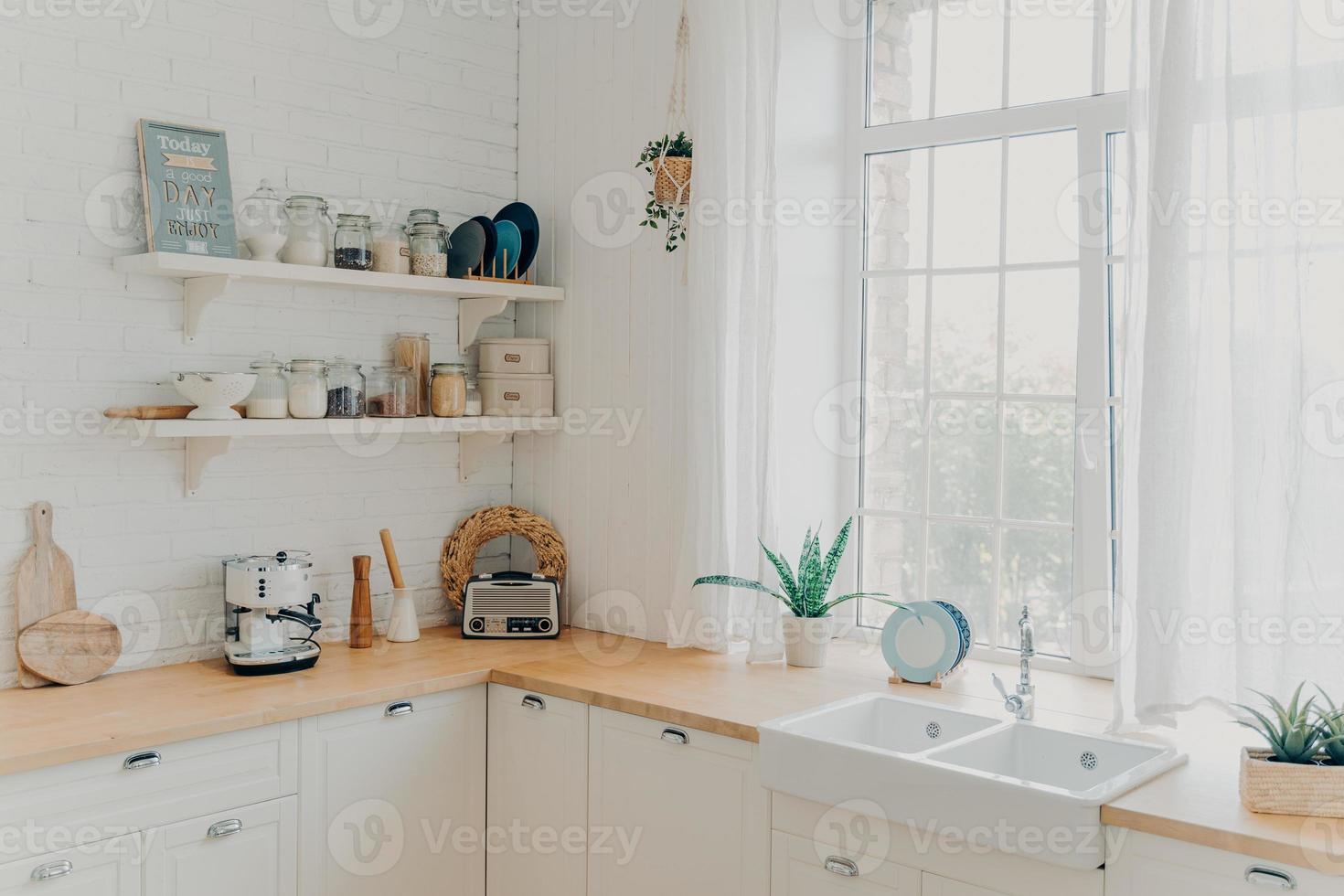 Brightly lit scandinavian kitchen with large window. Concept of mortgage and modern apartment. photo