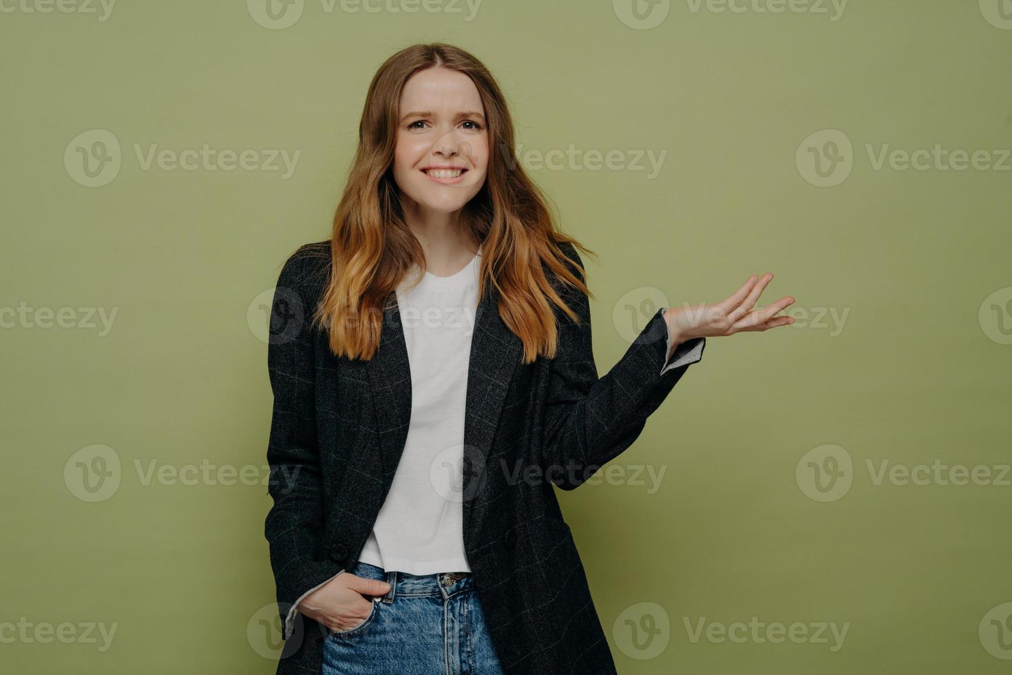 Pretty young female with tipping hand expressing confusion photo