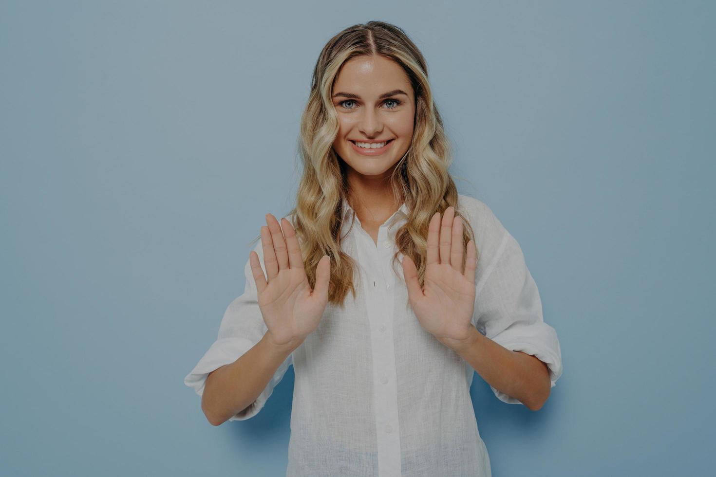 Blonde teenage girl politely refusing photo
