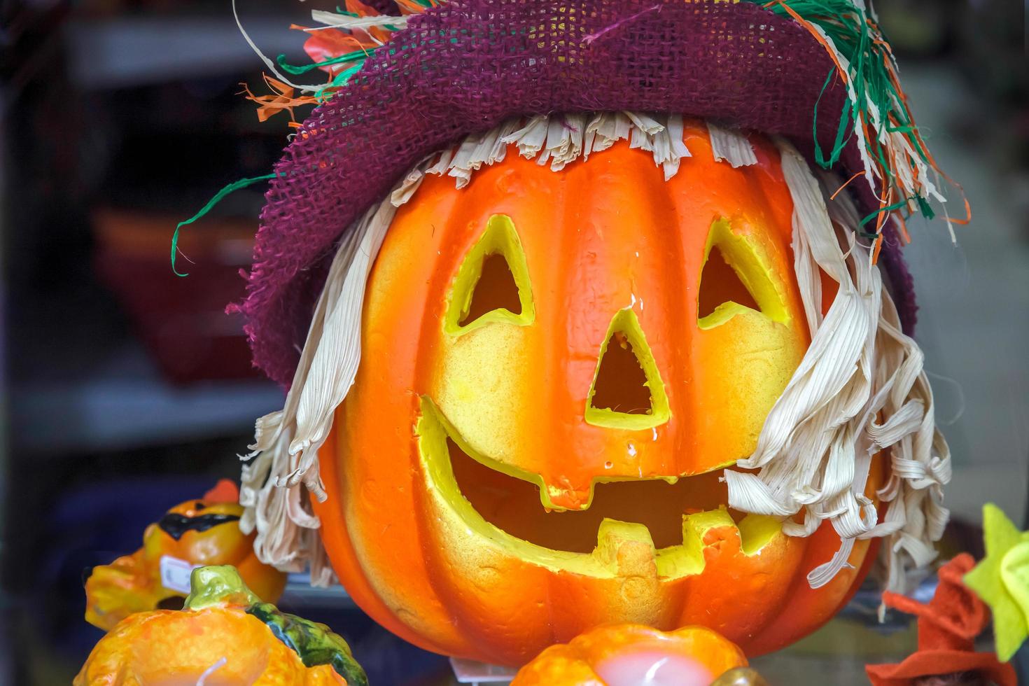 Monza, Italy, 2010. Close-up of a Pumpkin Carved Face in a Shop Window photo