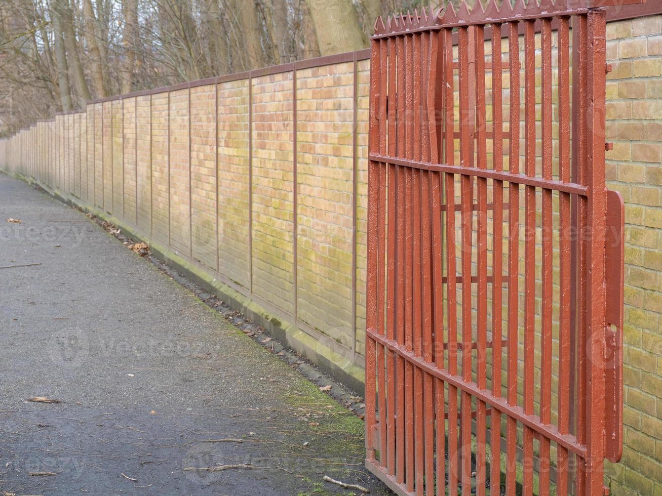 Closeup shot of aged brick wall with gate photo