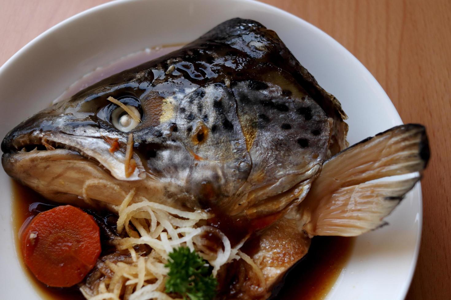 Boiled salmon head with soy sauce or Salmon kabutoni on white round