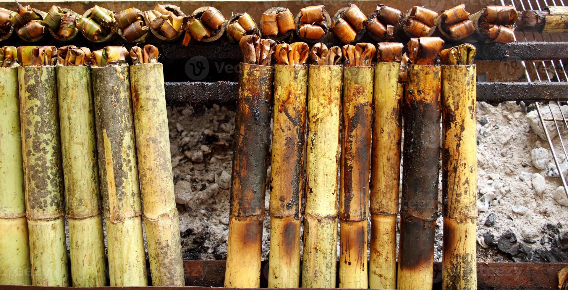 Sticky rice roasted in bamboo join or Khao Lam are roasting on stove. In Thailand Khao Lam is favorite thai dessert and must cracked the bamboo before eat. 7423190 Stock Photo at