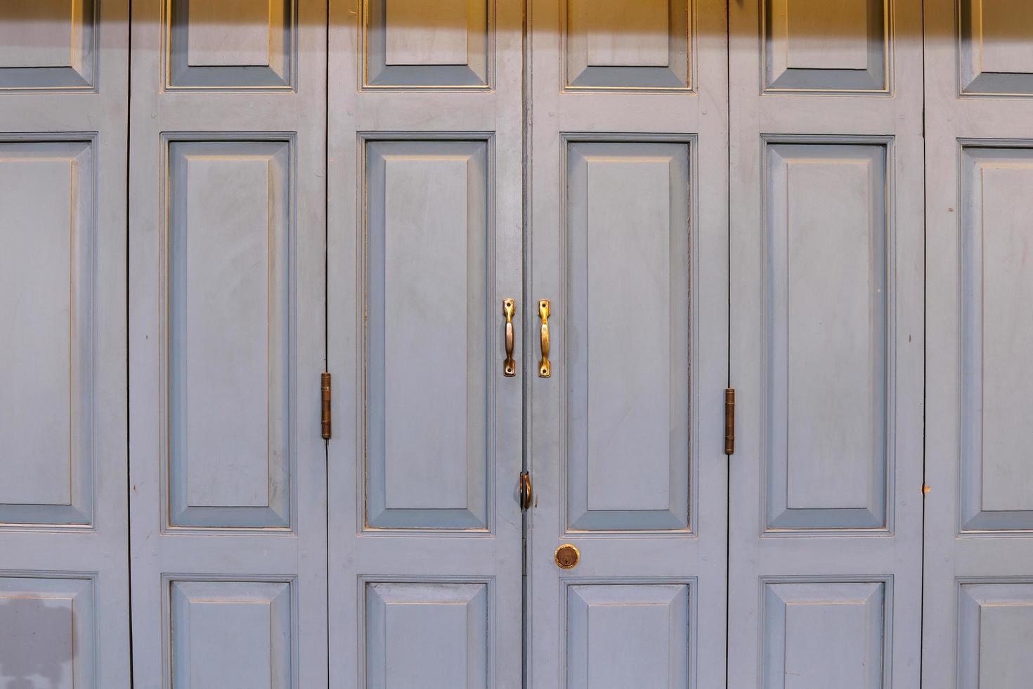 Old style wood doors are closed and light. photo