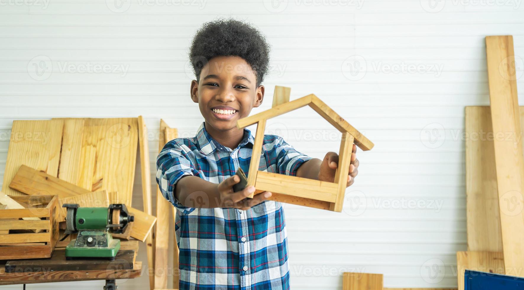 African American Male Carpenter Sitting at Table Showing Model Car