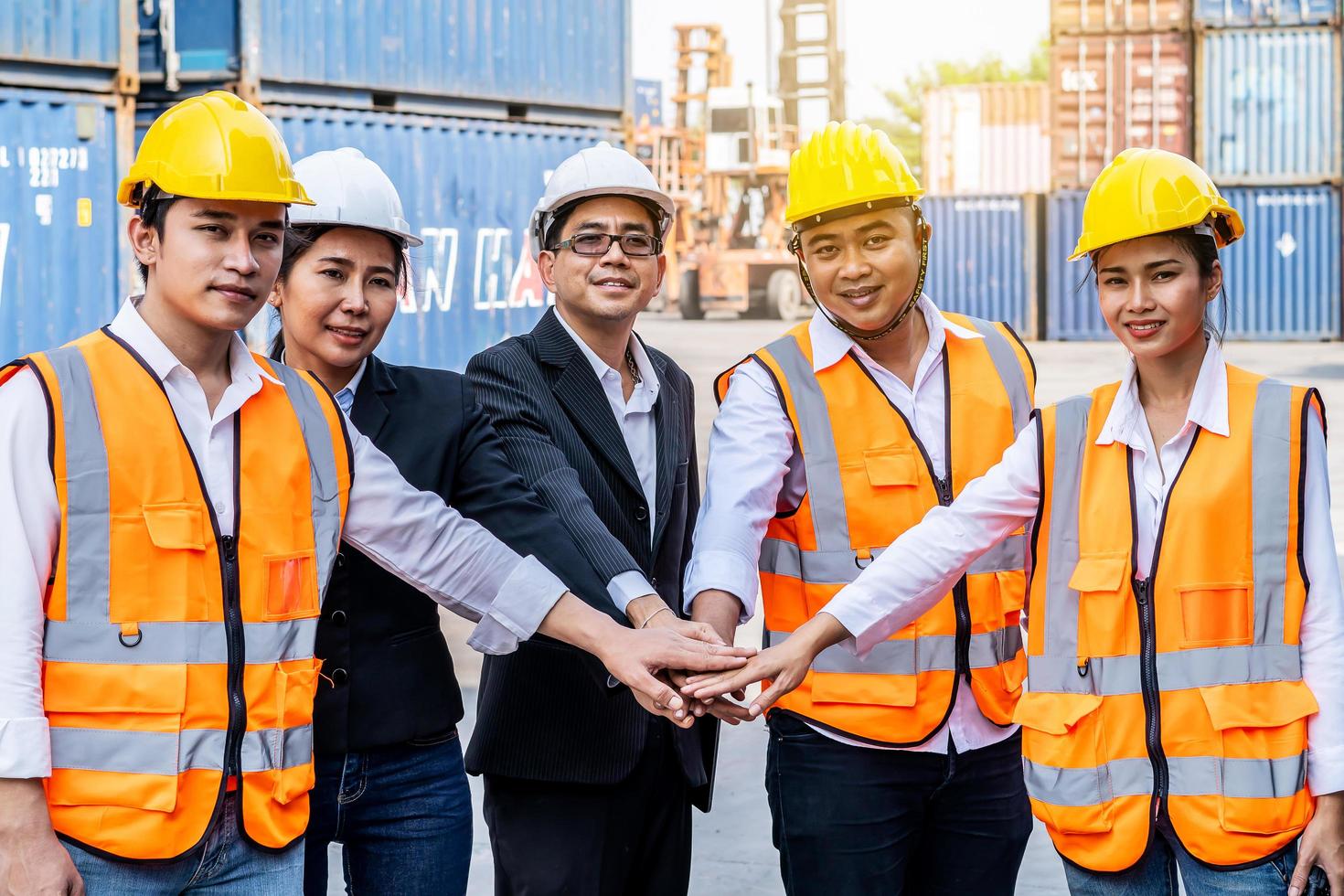 Group of employees and management team wearing logistic uniforms for exporting products abroad, stand to put your hands up and raise your hands together for a harmonious work experience photo