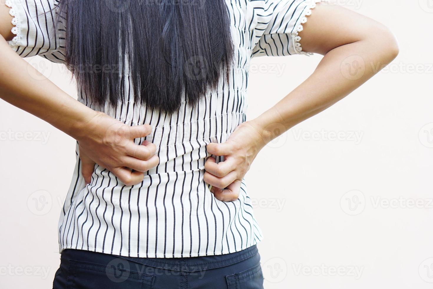 Backside of white woman back pain and ache concept,Itchy Asian woman in the back photo