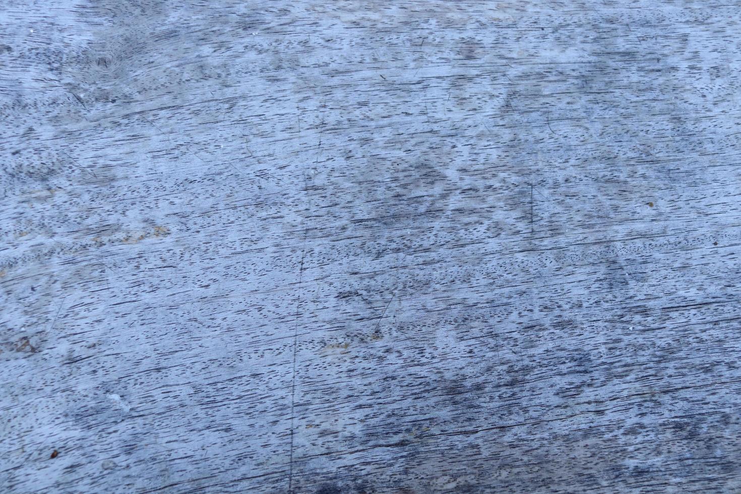 Light gray and old wood board background. Weathered surface of wood board and some stipes, porous. photo