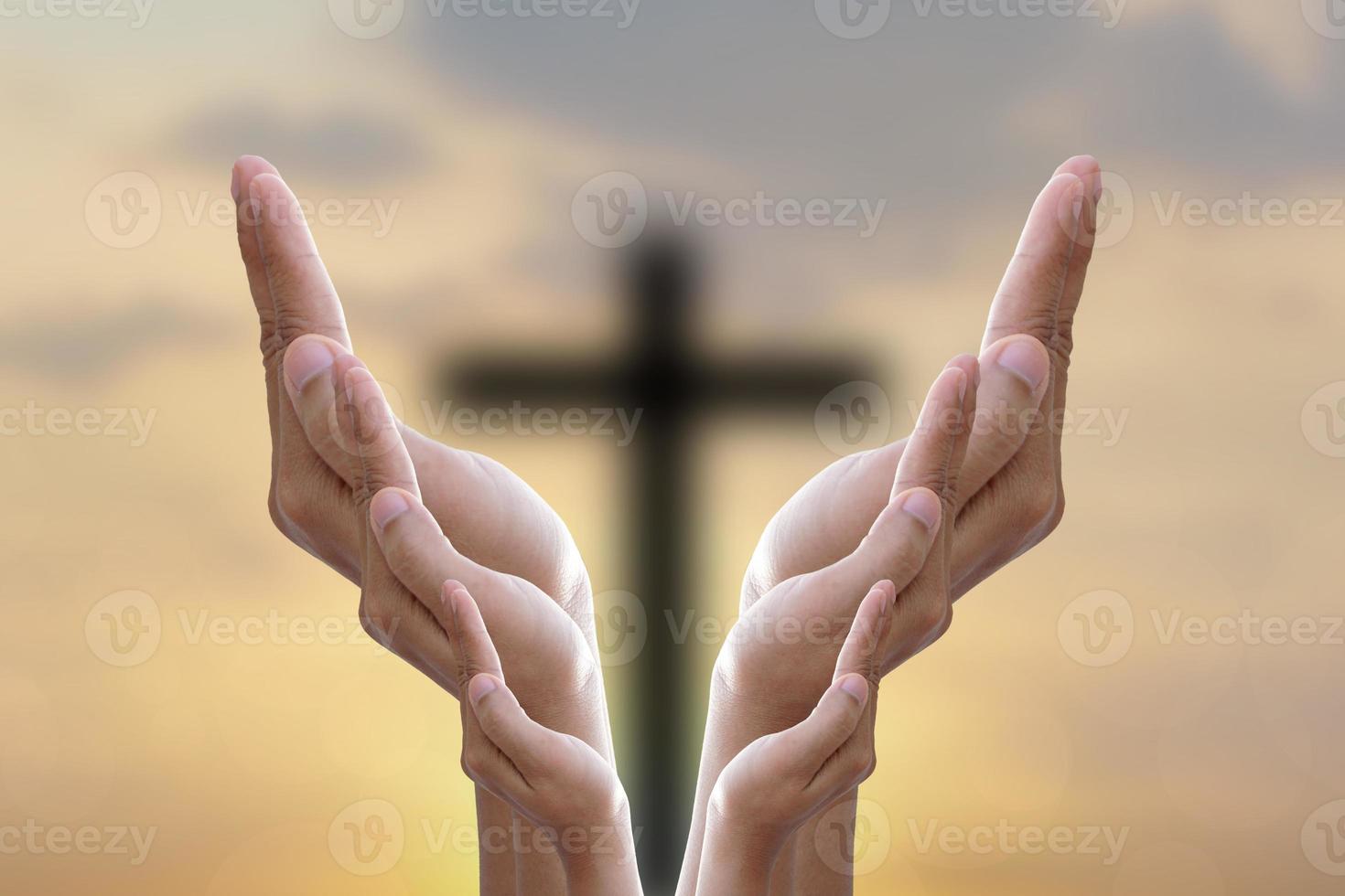 Hands bless the cross in the sky. photo