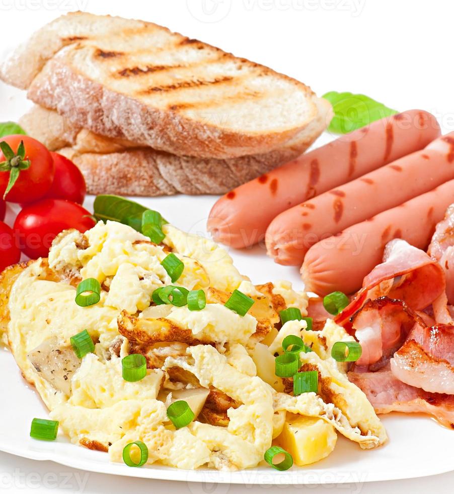 English breakfast - scrambled eggs, bacon, sausage and toast photo