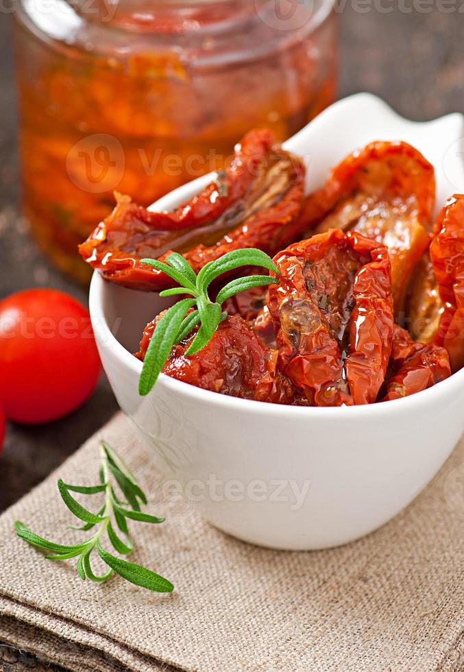 Dried tomatoes and rosemary photo