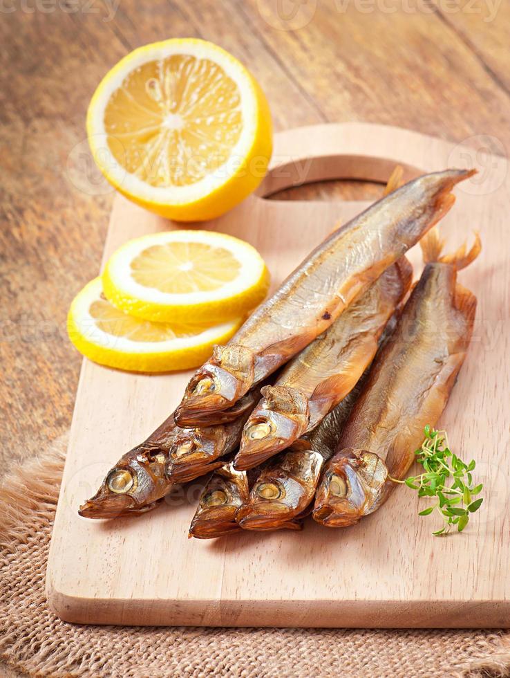 Smoked fish and lemon 7424812 Stock Photo at Vecteezy