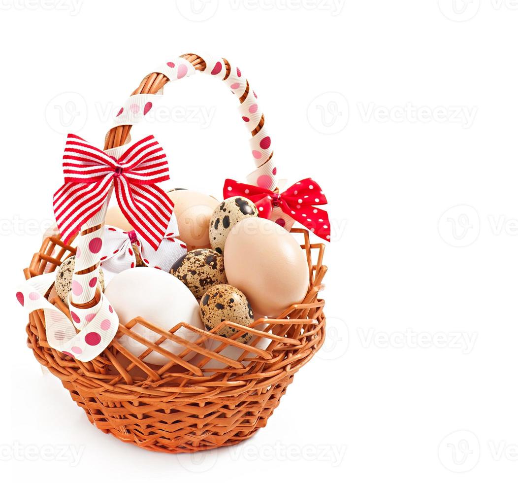 Easter eggs and basket on a wooden background photo